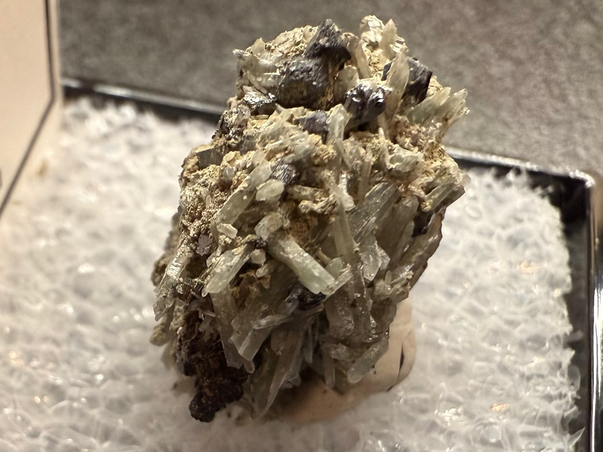 Mineral sample in a display case with a label