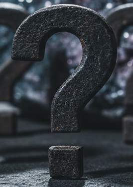 Mystery mineral - blurred out with bold dark question marks in foreground